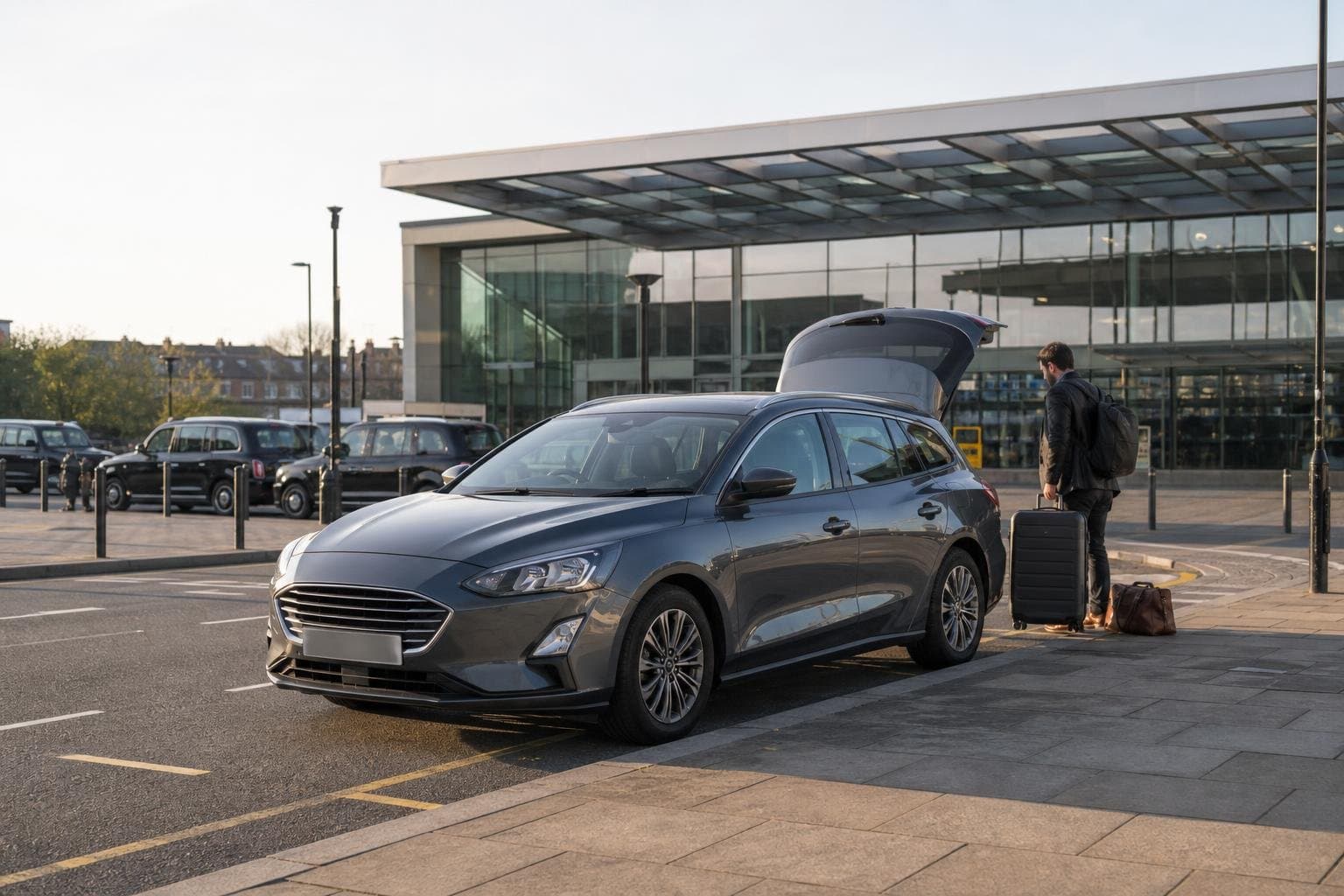 Mid-size hire car at a station approach with luggage for travel from Finchley